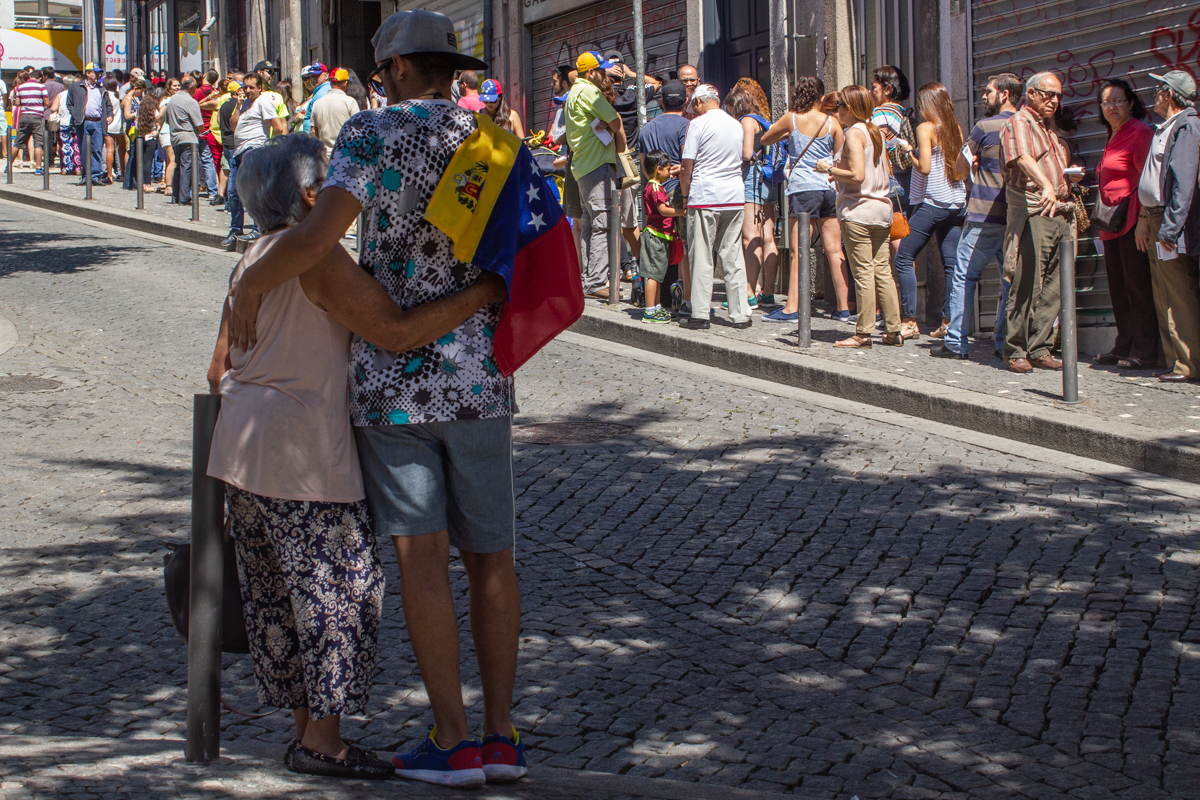 A person walking down a street holding a flag